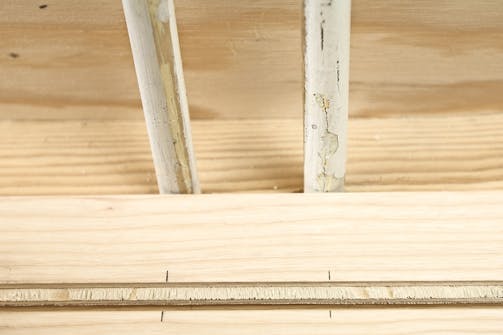 Samling mellem to langsgående gulvbrædder: Det første gulvbræt langs væggen saves til i bredden Samling mellem to langsgående gulvbrædder: Det første gulvbræt langs væggen saves til i bredden